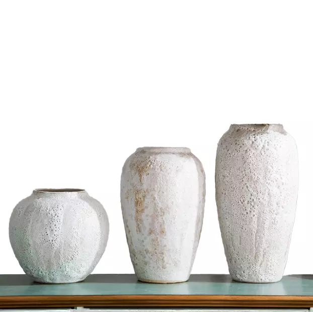 Set of three handmade rustic white textured ceramic vases in varying sizes