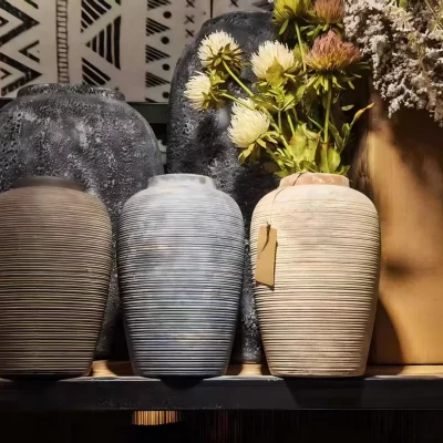Ribbed ceramic vases that hold the quiet beauty of imperfection.