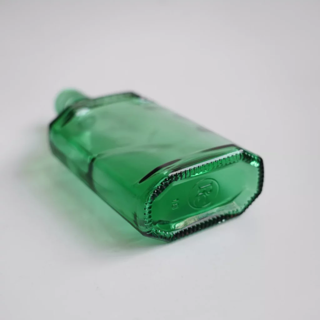 green flat glass bottle
